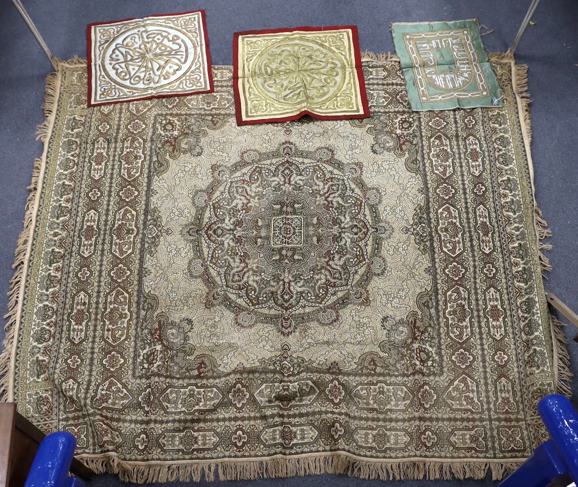 Two 19th century Indian heavy metallic thread embroideries on silk, another smaller similar panel and later 20th century machine woven fringed bedcover, two metal embroideries 53cm x 52cm